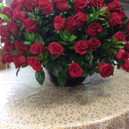 Large bouquet of red roses in a black vase