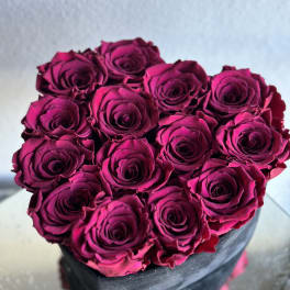 Bouquet of deep pink roses in a black box