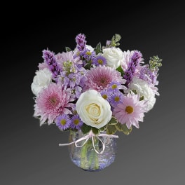 Pink and white mixed flower bouquet in a clear glass vase