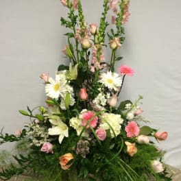 Tall mixed flower arrangement with pink roses, white lilies, and daisies