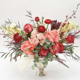 Mixed bouquet of red and pink roses in a silver vase