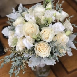 Bouquet of white roses and pale blooms with silvery foliage