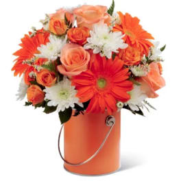 Orange and white flower bouquet in an orange bucket