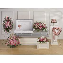 Pink floral funeral casket spray with matching standing arrangements