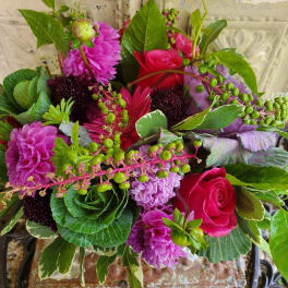 Bouquet of pink and purple flowers with green foliage
