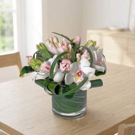 Pink and white orchid bouquet in a glass vase