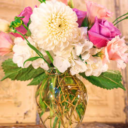Bouquet of white and pink flowers in a clear glass vase