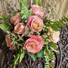 Pink and peach rose bouquet with fern and small white filler flowers