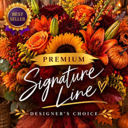 Autumn floral arrangement with sunflowers, lilies, roses, and pumpkins