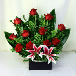 Red roses and pink-white lilies in a black rectangular box