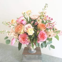 Pastel mixed flower arrangement in a silver vase