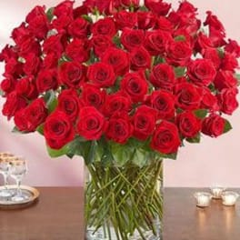 Large bouquet of red roses in a clear glass vase