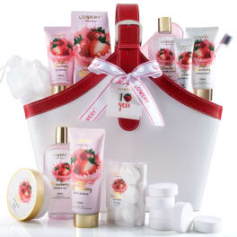Strawberry bath and body gift set in a white and red tote with assorted bottles and bath tablets