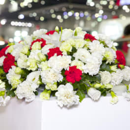 White and red floral arrangement on a table