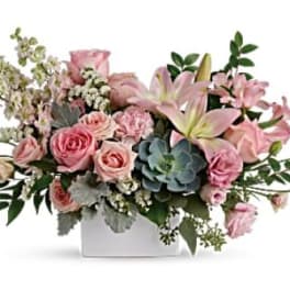 Pink roses and lilies in a white rectangular vase