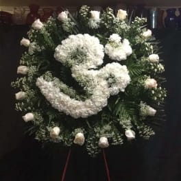 Large white funeral wreath with roses and clustered blooms