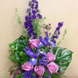 Purple and pink floral arrangement with roses and iris