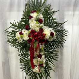 Standing floral spray with red roses and white chrysanthemums on an easel