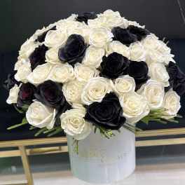 Black and white rose arrangement in a white hat box