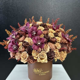 Bouquet of purple orchids and dried roses in a brown box