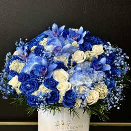 Blue and white floral arrangement in a white box