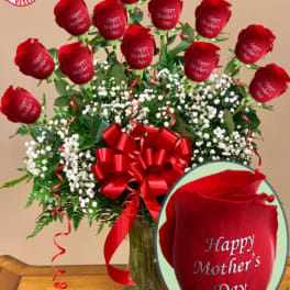 Bouquet of red roses with a red ribbon in a glass vase