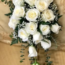 Bouquet of white roses with baby's breath and trailing greenery
