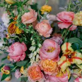 Mixed bouquet of pink and peach flowers in a vase