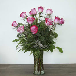 Pink roses arranged in a clear glass vase