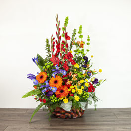 Colorful mixed flower arrangement in a woven basket