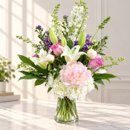Pink and white floral arrangement in a clear glass vase