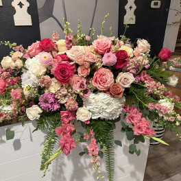 Large pink and white floral arrangement with roses and hydrangeas