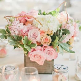 Pink and white rose centerpiece in a wooden box