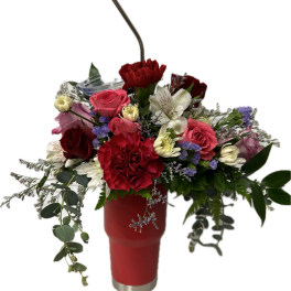 Mixed bouquet in a red tumbler with a straw