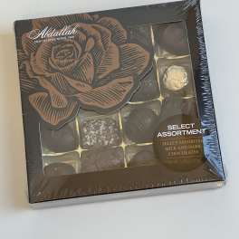 Box of assorted milk and dark chocolates with a rose design on the lid