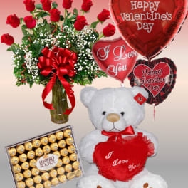 Red roses with balloons, a teddy bear, and chocolates for Valentine’s Day