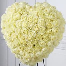Heart-shaped bouquet of pale yellow roses on a stand