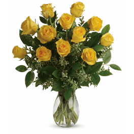 Yellow roses arranged in a clear glass vase
