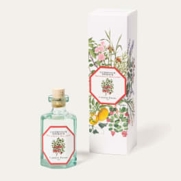 Perfume bottle beside a floral-patterned box