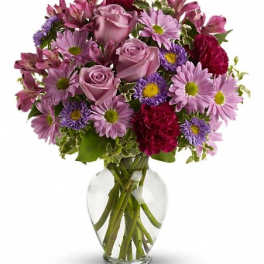 Pink and purple mixed bouquet in a clear glass vase