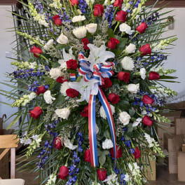 Large standing floral spray with red and white roses and white lilies