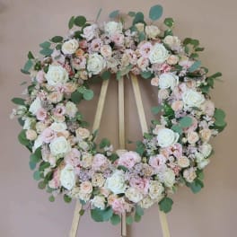 Pastel floral wreath on a wooden easel