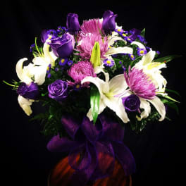 Purple and white floral bouquet with a purple ribbon bow