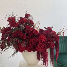 Large arrangement of red roses in a white vase
