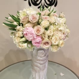 Blush and white rose bouquet in a tall white vase