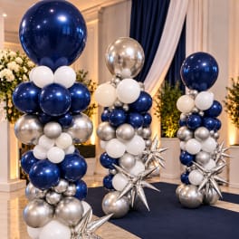 Tall balloon columns in navy, silver, and white with star accents