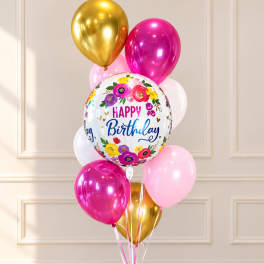 Birthday balloon bouquet with gold, pink, and white balloons
