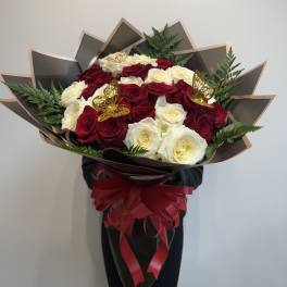 Large bouquet of red and white roses with a red ribbon