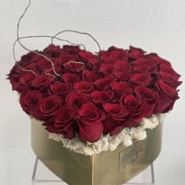 Heart-shaped box filled with red roses