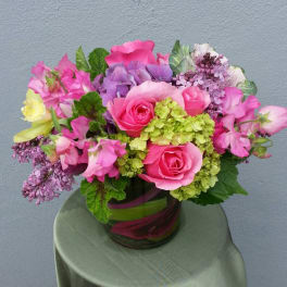 Pink and purple floral arrangement in a glass vase